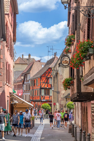 Ribeauville, France - June 23, 2023: A picturesque colorful street of half-timber buildings with shops and cafes in the village of Ribeauville, in the Alsace region.のeditorial素材