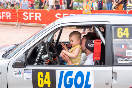 Geraldmer, France - June 18, 2023: rally driver with his child at the drivers position on the way to the official welcome greeting of the Geraldmer rally trophy.のeditorial素材