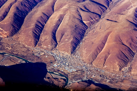 beautiful view from the aircraft to the mountains of the Himalayas on Chinese Tibetan side, the...