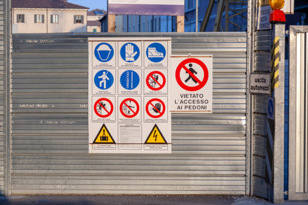 Verona, Italy - August 4, 2009: shutter wall in chrome with signs how to bring safety to a construction site, warning signs.のeditorial素材