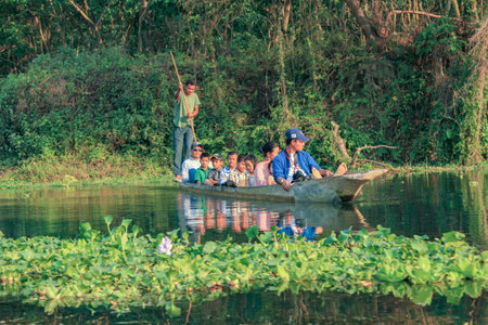 Chitwan, Nepal - March 31, 2014: people on a boat trip at the river in Chitwan national park in...