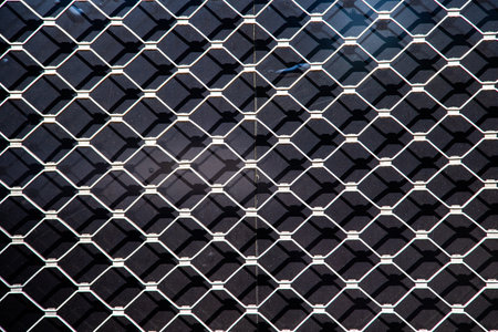 Harmonic metal grid texture in detail gives a harmonic background symbolizing modern techniqueの写真素材