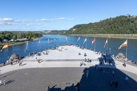 Koblenz, Germany - September 24, 2023: people promenade at river Rhine in Koblenz at Deutsches Eck or German Corner in Koblenz, where the Mosel river joins the Rhine.のeditorial素材