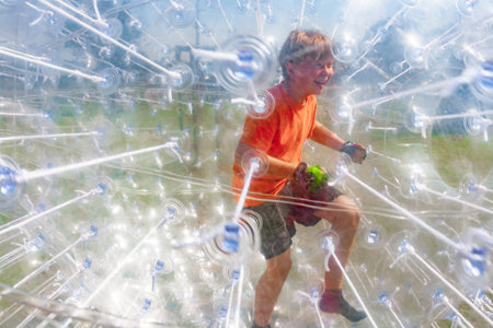 Children have a lot of fun in the Zorbing Ballの写真素材
