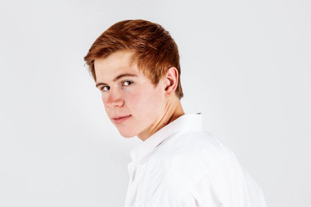 portrait of handsome red haired teenager isolated on whiteの写真素材