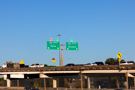Highway 45 with direction signage Dallas and Galveston under blue sky