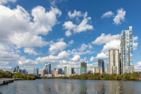 Skyline of Austin in early morning light with mirroring city in the Colorado river, Texas, USAの写真素材
