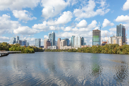 Skyline of Austin in early morning light with mirroring city in the Colorado river, Texas, USAの写真素材