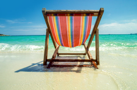 wooden chair at the beach with ocean viewの写真素材