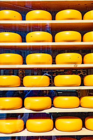 yellow round cheese wheel as decoration in the shop window
