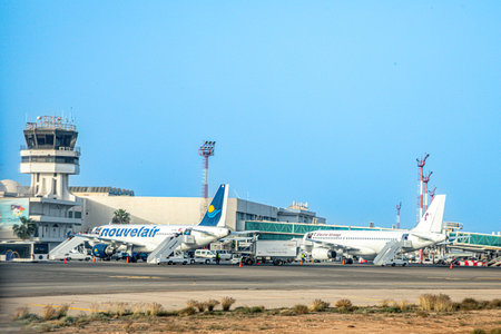 Djerba, Tunisia - April 27, 2024: view to new Terminal of Airport Djerba Zarzis in Tunisia. with passenger bridges and aircraft.のeditorial素材