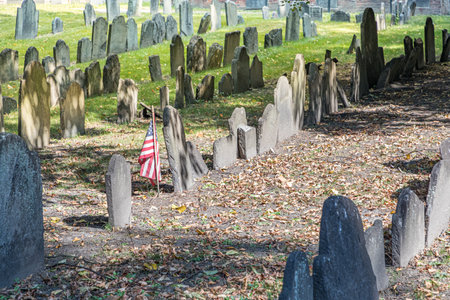 BOSTON, USA - SEP 12, 2017: Rows of headstones under a tree at Granary Burial Ground. It became a cemetery in 1660, the third oldest in the town of Boston, Massachusetts.のeditorial素材
