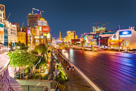 Las Vegas, USA - July 17, 2008: View to the Strip in Las Vegas by night with cars on the street and neon lights in the bars, hotels and gambling places in Las Vegas, USA.のeditorial素材