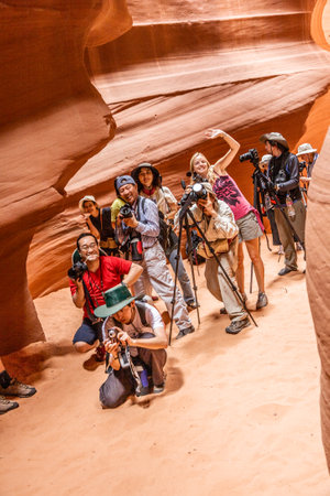 PAGE, USA - JULY 14, 2008: : Photographers shooting the upper Antelope Canyon in Midday light in Page, USA. The Indians offer special guided tours for photographers to get the best light.のeditorial素材