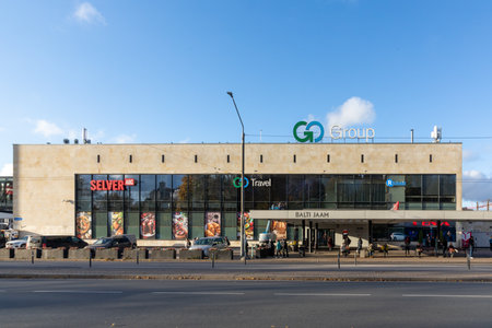 Tallinn, Estonia - October 25, 2024: Bus and streetcar station Balti Jaam with shopping center in background and people waiting for the bus in Tallinn.のeditorial素材