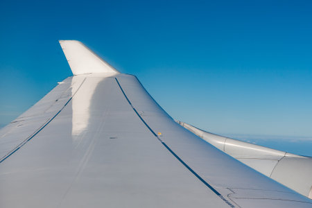 detail of wing of aircraft in blue skyの写真素材
