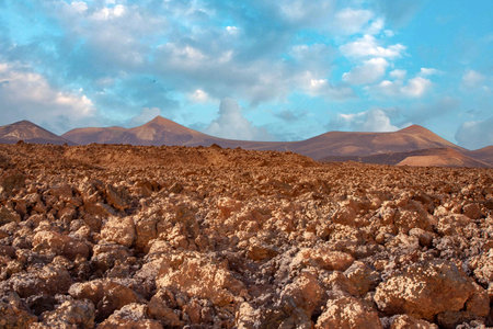 View to old volcanos in Timanfaya national park in sunset moodの写真素材
