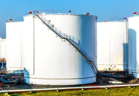 white tank in tank farm with blue skyの写真素材