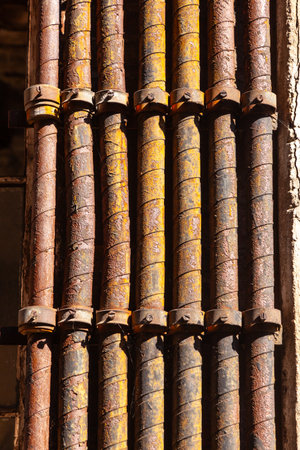 detail of old industrial brick wall with rotten and rusty water and gas pipes as symbol and lost place for industryの写真素材