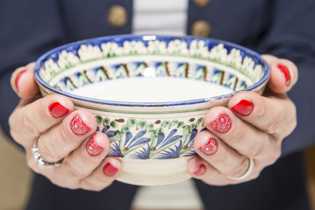 Red nail art design with a white pattern and piala with kumisの写真素材