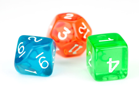 Three colorful translucent dice, on whiteの写真素材