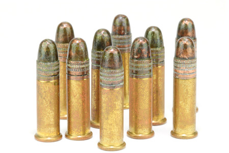 Ten, twenty-two   22  caliber rifle rounds, standing, on whiteの写真素材