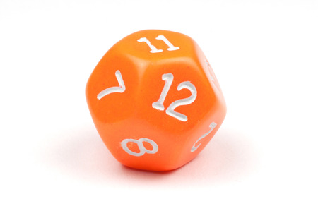 A single, orange, 12-sided die on whiteの写真素材