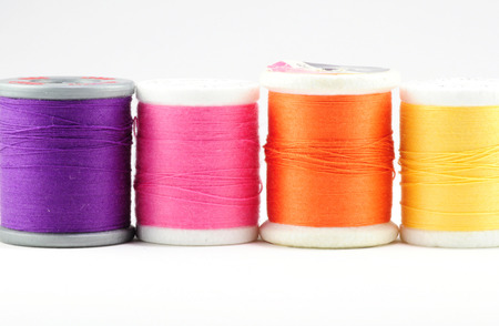 Four spools of thread on whiteの写真素材