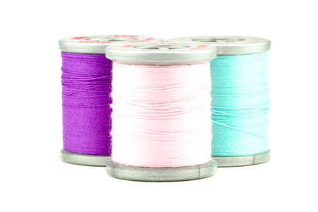 Three small spools of thread, on whiteの写真素材