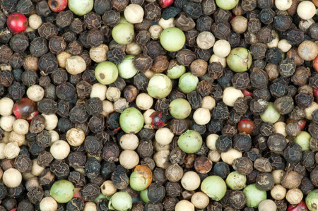 Macro photo of many black, white, red, and green peppercornsの写真素材