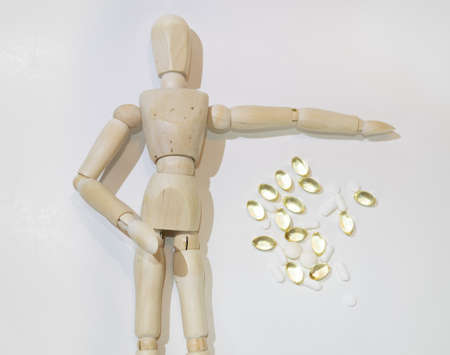 The dangers of Drug overdose concept, symbolized by an anonymous wooden mannequin. white backgroundの写真素材