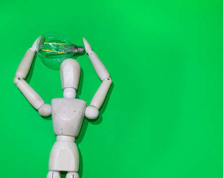 Mannequin Wood Figure carrying an incandescent light bulb. New idea concept. green screenの写真素材