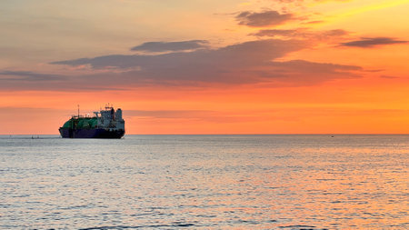 Cargo ship in the sea at sunset, beautiful nature background.の写真素材