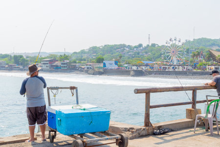 Photo of Puerto de la Libertad and Mercado del Mar with the restaurants on the shore and sunset park. surf townのeditorial素材
