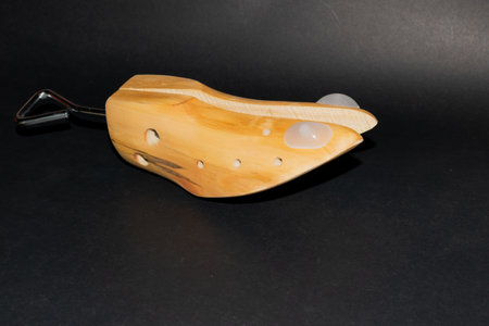 Shoe stretcher on a sleek black background.の写真素材