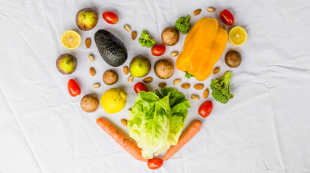 Close up photo of fresh fruit and vegetables on a white background