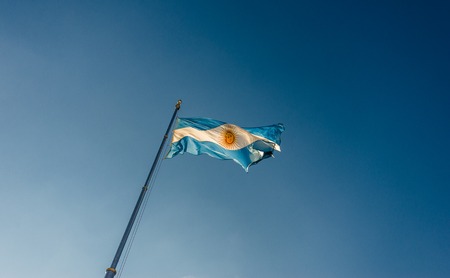 Argentina flag waving against blue sky on a sunny day