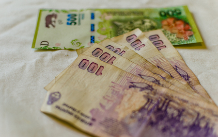 Close up photo of Argentina money, bills of 100 and 500 peso