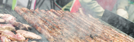 Argentina barbecue asado chorizo sausages and meat cooking on parilla grillの写真素材