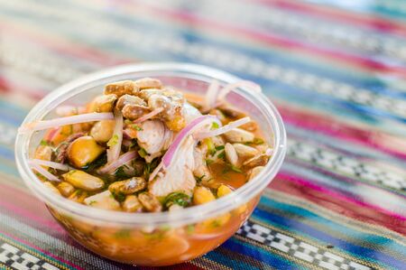 Peruvian mixed ceviche with red onion and fried corn at a street food marketの写真素材