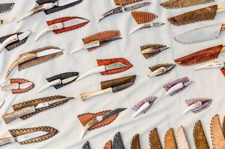 Flat lay photo of knives with bone handles against white background