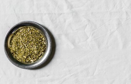 Yerba mate tea on a metal plate against white backgroundの写真素材