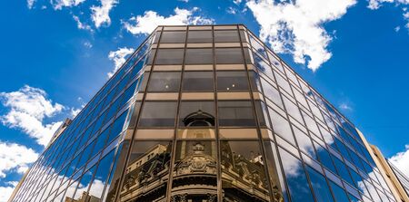 Reflection of a church on a glass building in Buenos Aires on Reconquista street