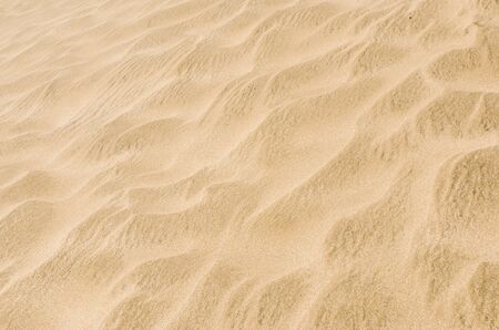 White and yellow sand on desert beach