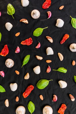 Selection of different Italian food ingredients against black backgroundの写真素材