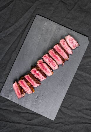 New york strip porterhouse steak beef meat with garnished and spicesの写真素材