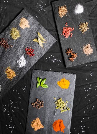 Large selection of different colorful contrast spices and seedsの写真素材