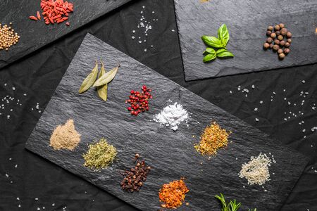 Large selection of different colorful contrast spices and seedsの写真素材