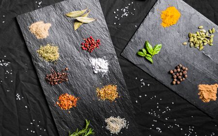 Large selection of different colorful contrast spices and seedsの写真素材