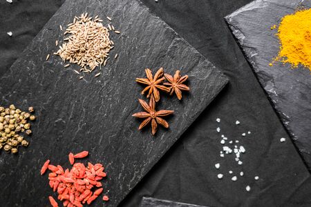 Large selection of different colorful contrast spices and seedsの写真素材